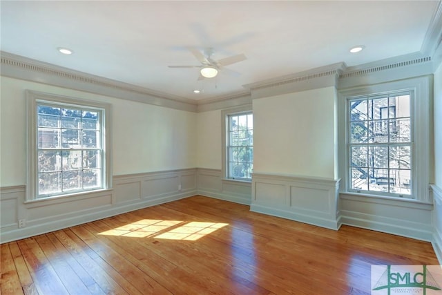 spare room featuring ceiling fan, ornamental molding, and light hardwood / wood-style floors