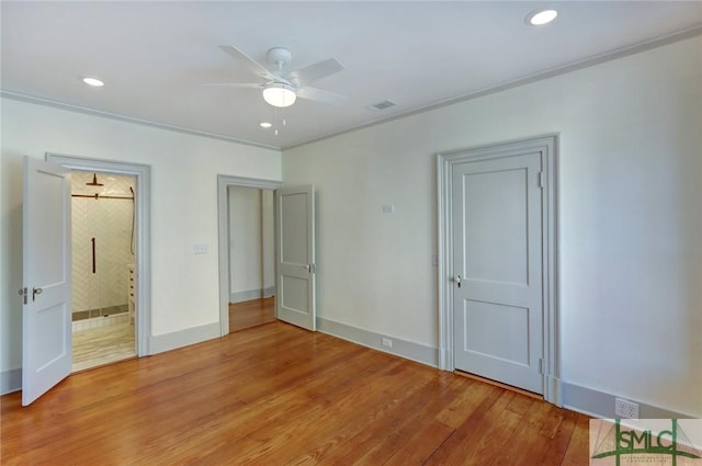 unfurnished bedroom with crown molding, wood-type flooring, and ceiling fan