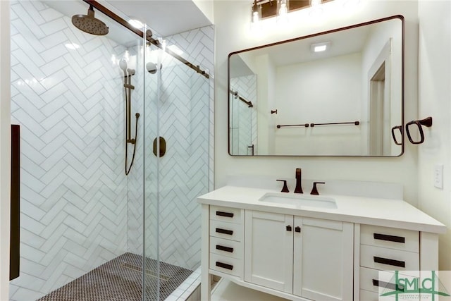 bathroom featuring vanity and a shower with door