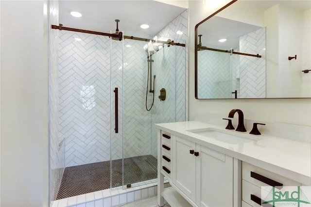 bathroom with vanity and an enclosed shower