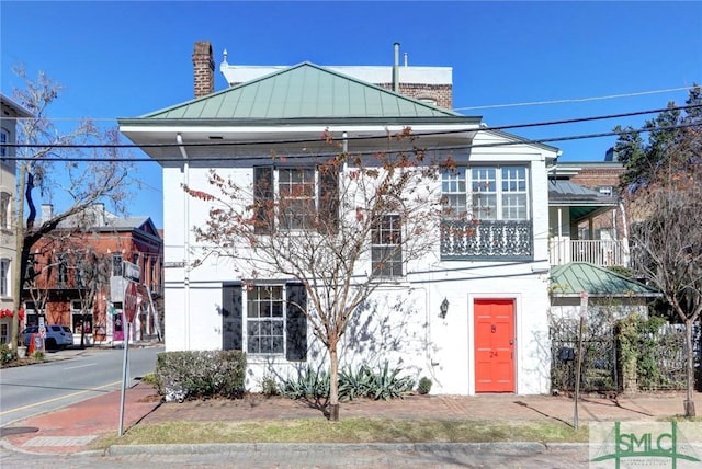 view of front of house featuring a balcony