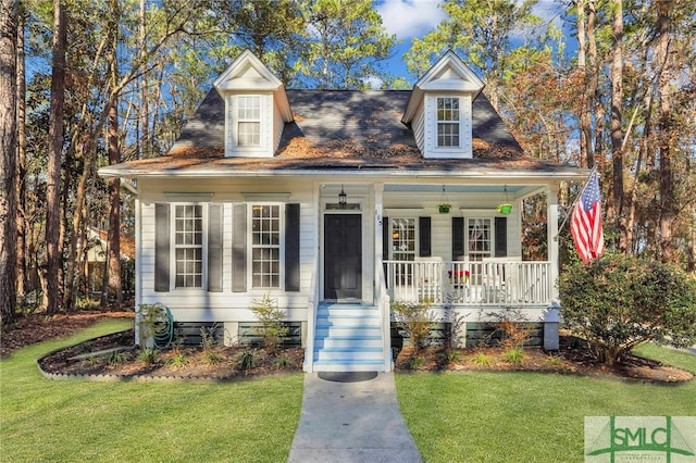 view of front of house with a porch and a front yard