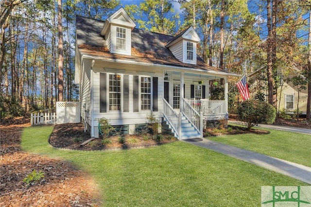 new england style home with a porch and a front lawn