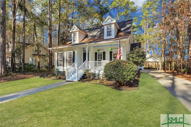 new england style home featuring a front yard and a porch