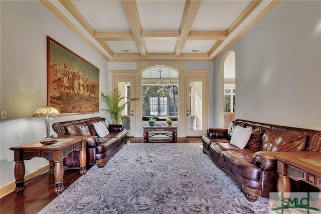 living room featuring coffered ceiling, hardwood / wood-style floors, ornamental molding, and beamed ceiling