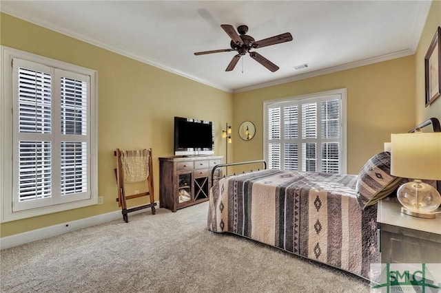 carpeted bedroom featuring crown molding and ceiling fan