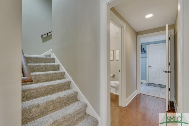 stairway featuring wood-type flooring