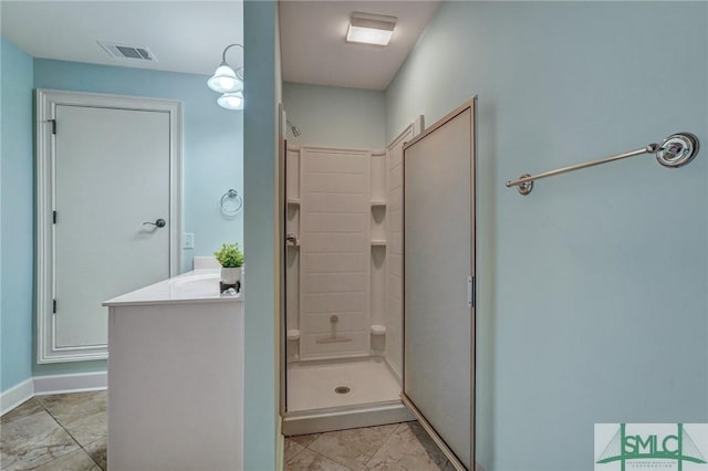 bathroom featuring vanity and a shower with door