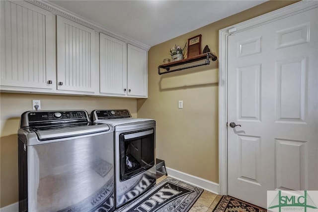 laundry area featuring cabinets, separate washer and dryer, and light tile patterned floors