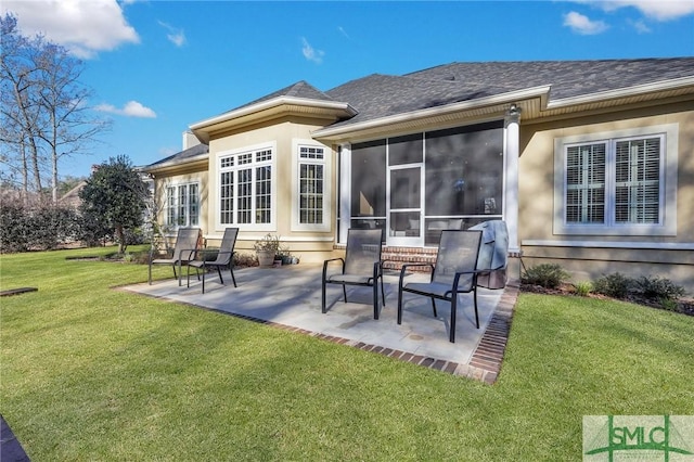 back of house with a yard, a sunroom, and a patio area