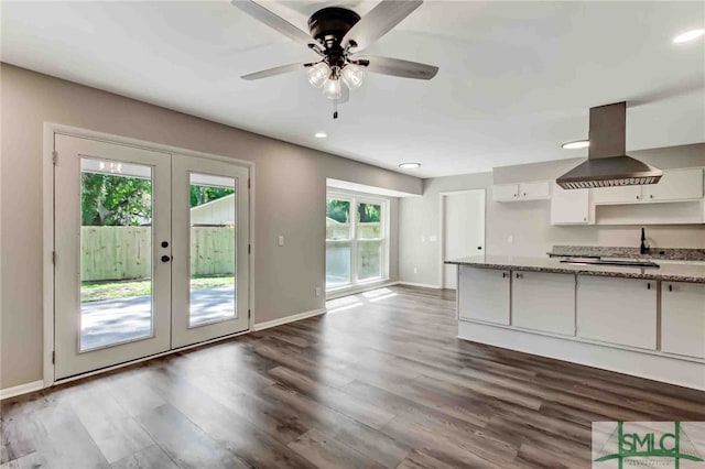 kitchen with white cabinetry, a healthy amount of sunlight, island range hood, and french doors