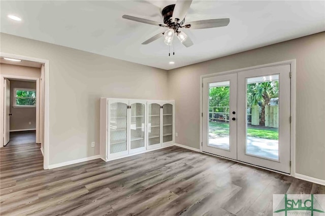 interior space with hardwood / wood-style floors, ceiling fan, and french doors