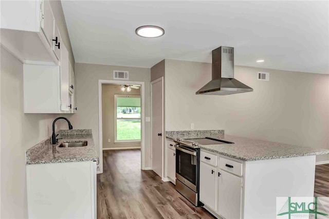 kitchen with white cabinets, island exhaust hood, and stainless steel range with electric stovetop