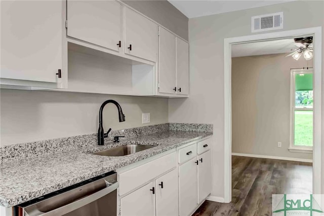 kitchen featuring dark wood-type flooring, sink, white cabinetry, stainless steel dishwasher, and ceiling fan