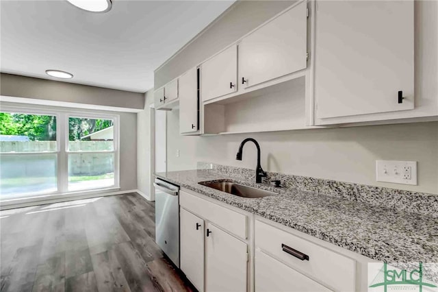 kitchen featuring stainless steel dishwasher, light stone countertops, sink, and white cabinets