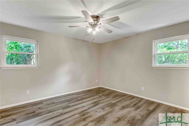 unfurnished room with hardwood / wood-style flooring and ceiling fan