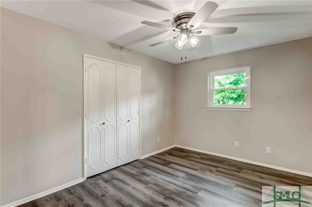 unfurnished bedroom with hardwood / wood-style flooring, a closet, and ceiling fan