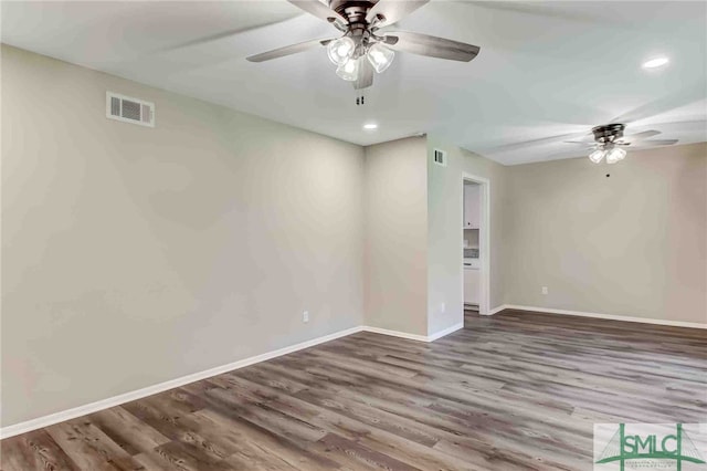 spare room featuring hardwood / wood-style floors and ceiling fan