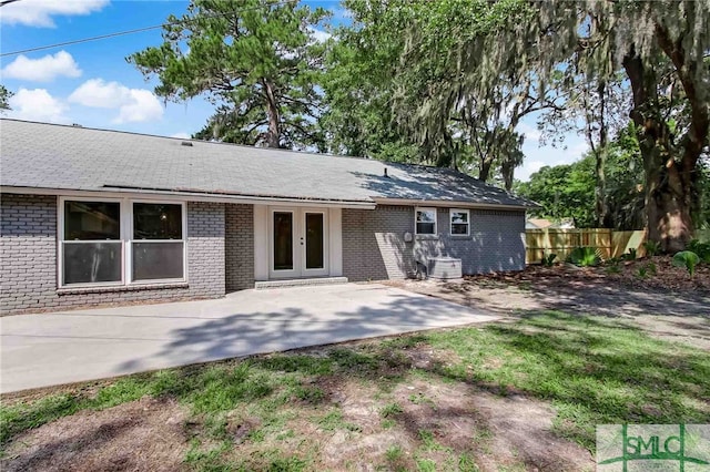 rear view of house with french doors, central AC, and a patio