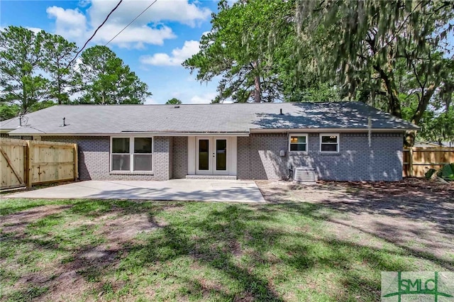 back of property featuring french doors, a yard, and a patio area