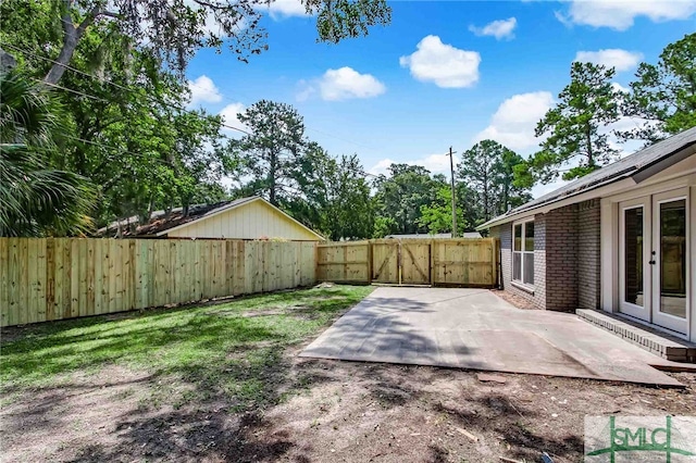 view of yard featuring french doors and a patio area