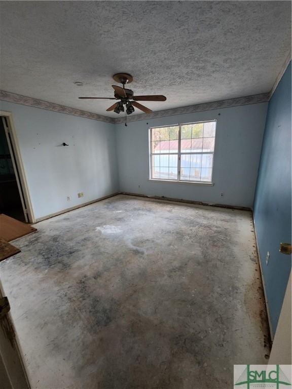 spare room with ceiling fan and a textured ceiling