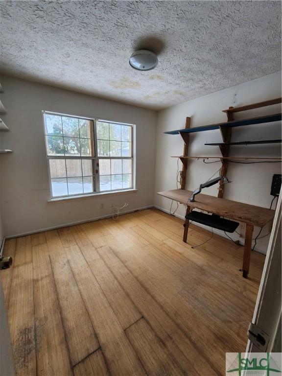 interior space featuring a textured ceiling and light hardwood / wood-style flooring