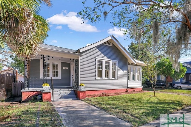 view of front of house with a front yard and covered porch