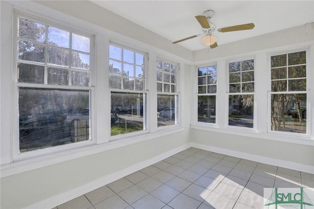 unfurnished sunroom featuring ceiling fan