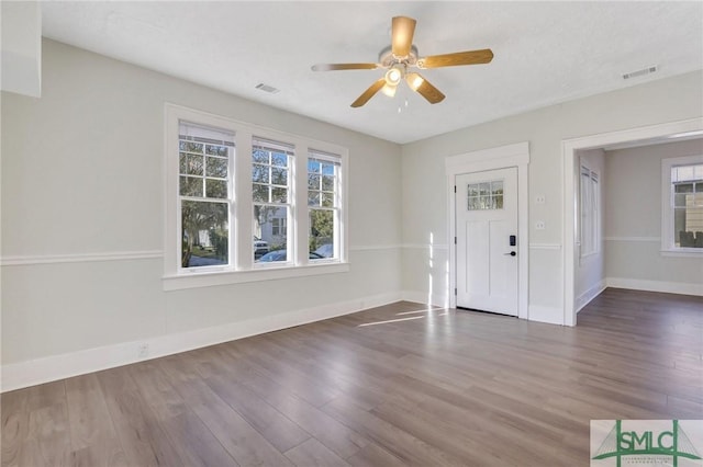 foyer entrance with ceiling fan and dark hardwood / wood-style floors