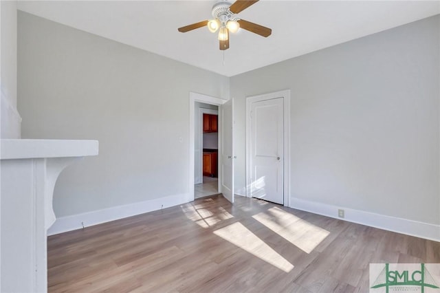 empty room featuring ceiling fan and light wood-type flooring