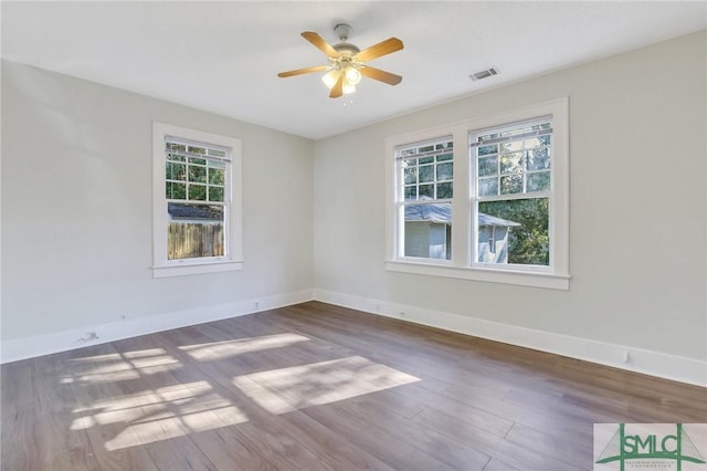 empty room featuring dark hardwood / wood-style floors and ceiling fan