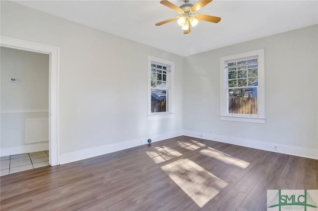 empty room with ceiling fan and hardwood / wood-style floors