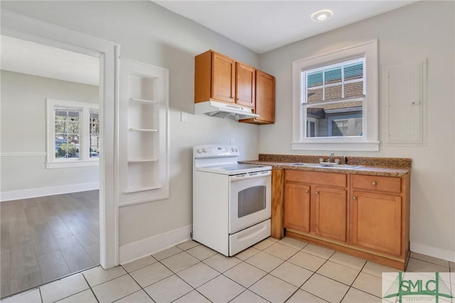 kitchen with white electric range, sink, and light tile patterned floors