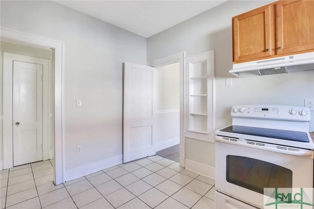 kitchen featuring light tile patterned floors, built in features, and white range with electric cooktop