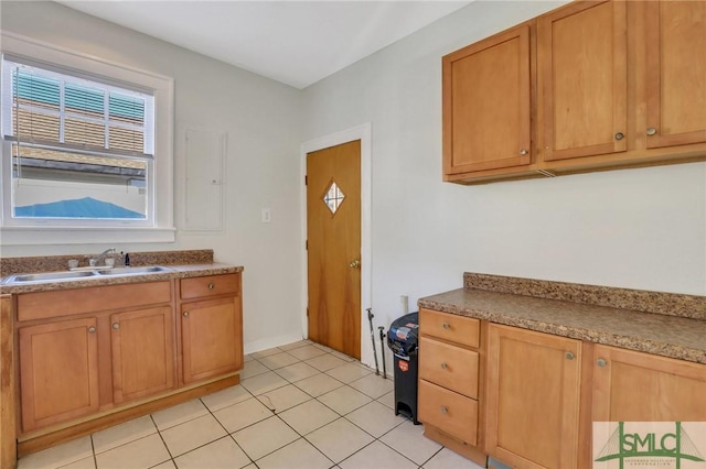 kitchen featuring sink and light tile patterned floors