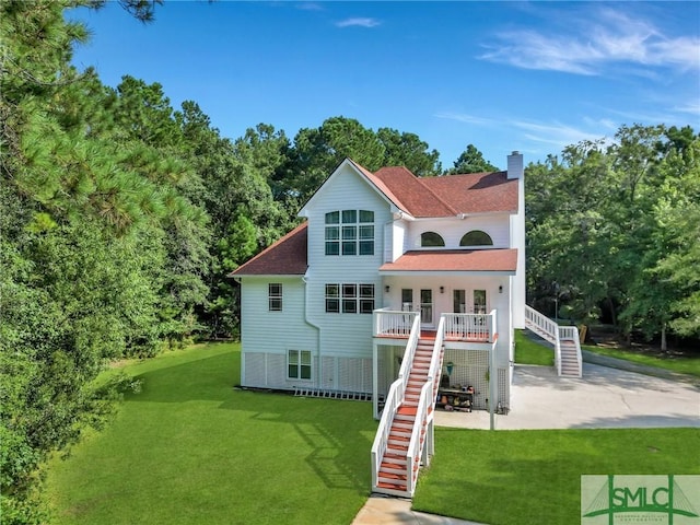 back of house featuring a patio and a yard