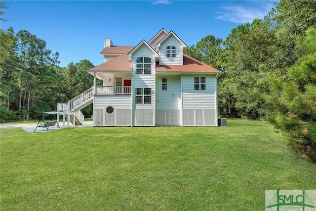 rear view of house with a yard