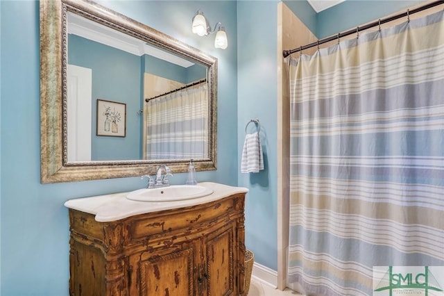 bathroom featuring crown molding, tile patterned floors, and vanity