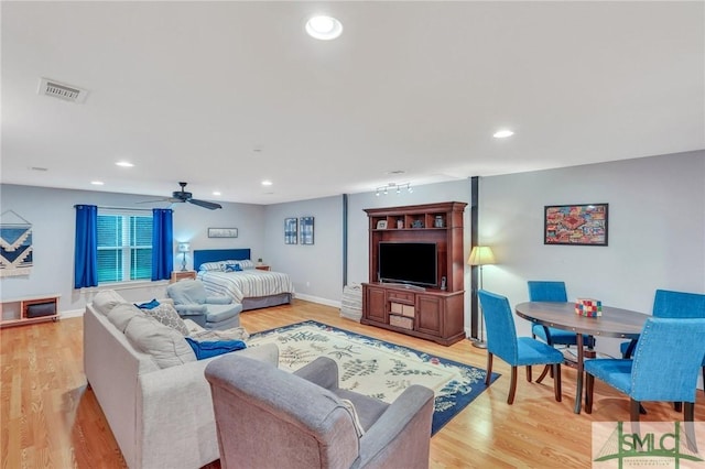 living room featuring ceiling fan and light wood-type flooring