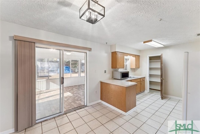 kitchen with light tile patterned flooring and a textured ceiling