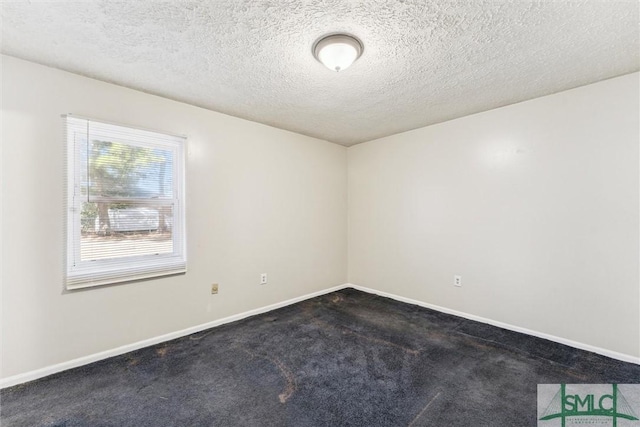 carpeted spare room featuring a textured ceiling