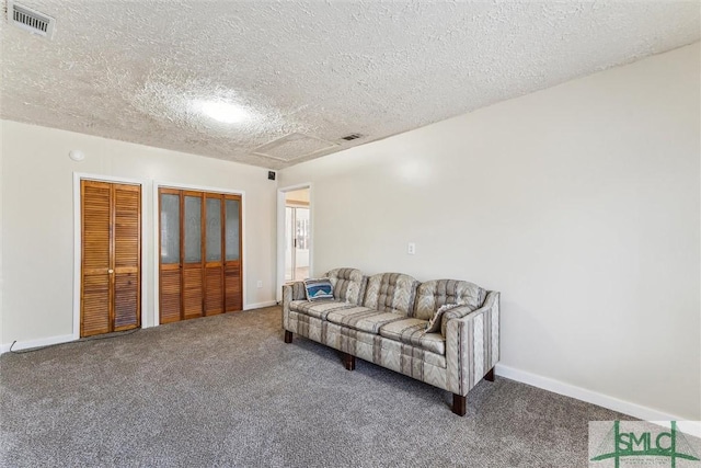 carpeted living room with a textured ceiling