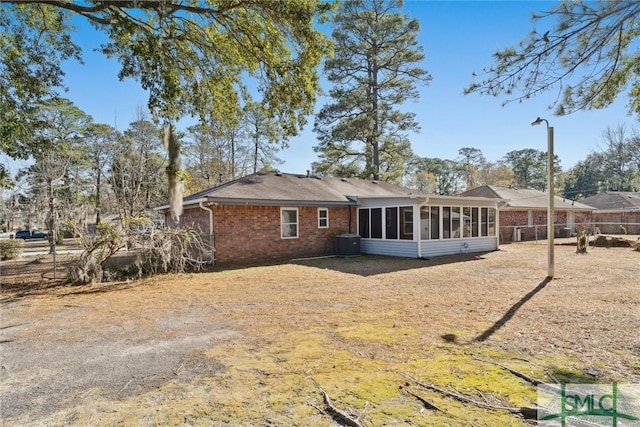 back of property featuring central AC and a sunroom