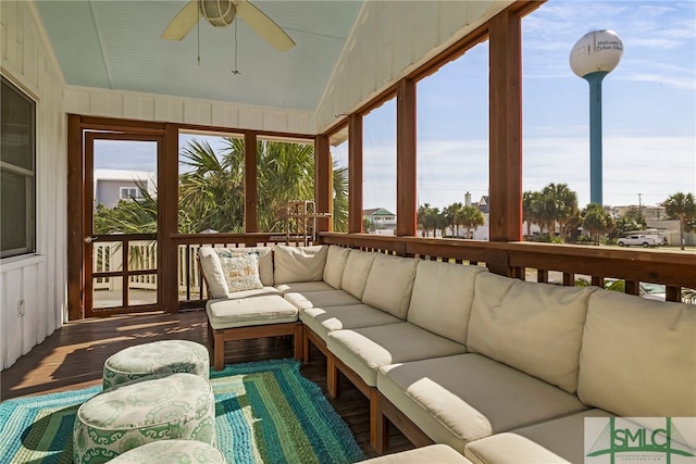 sunroom / solarium with ceiling fan and vaulted ceiling