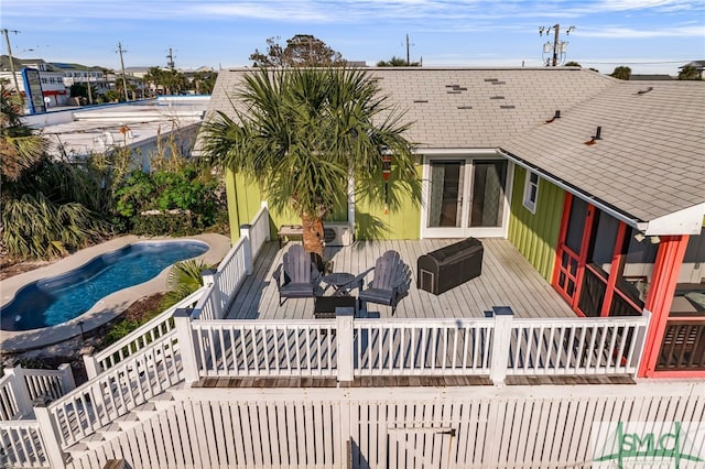 view of swimming pool featuring a wooden deck and french doors