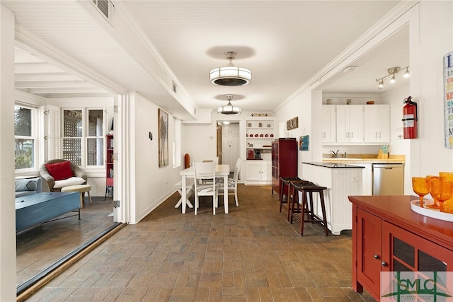 dining area featuring crown molding and sink