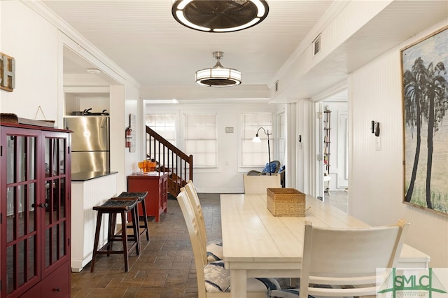 dining space featuring ornamental molding