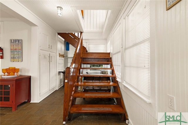 staircase featuring ornamental molding