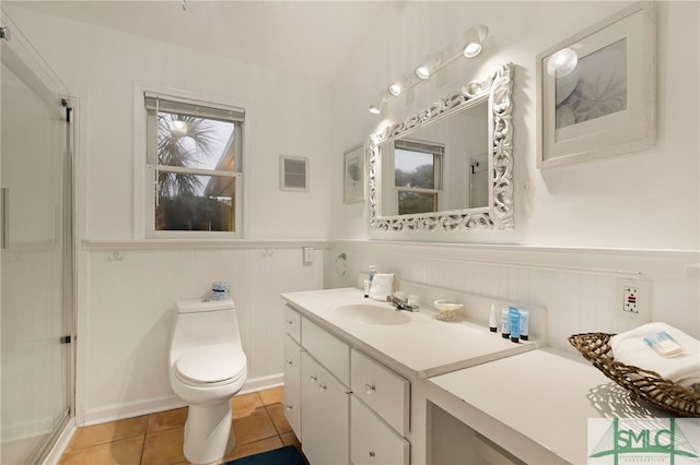 bathroom featuring walk in shower, tile patterned floors, toilet, and vanity